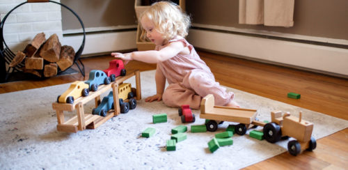 Young Girl playing with Truck Car Carrier