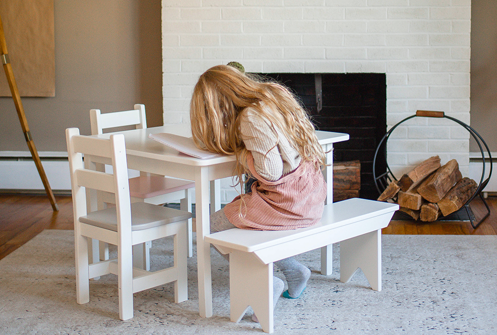Young girl sitting at table